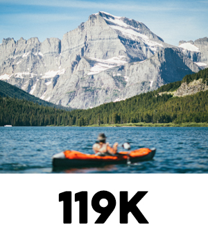 Image of a kayaker on a lake in the mountains at 119K