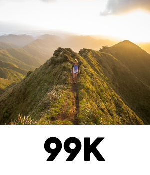 Image of a woman hiking mountain trails at sunrise at 99K